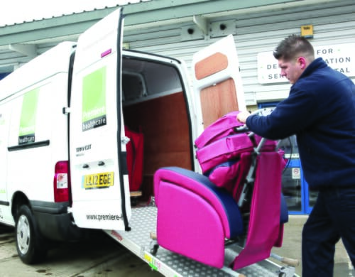 Man moving specialist seating into van