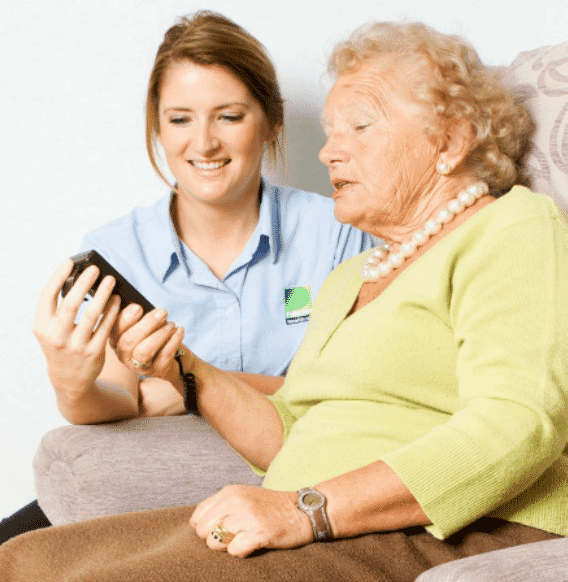 Assessor advising an elderly patient on specialist seating
