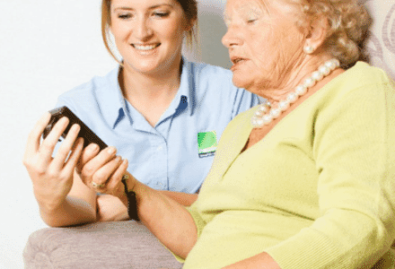 Assessor advising an elderly patient on specialist seating