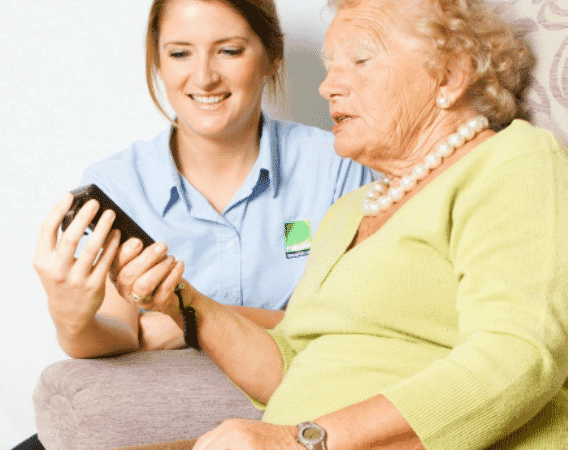 Assessor advising an elderly patient on specialist seating
