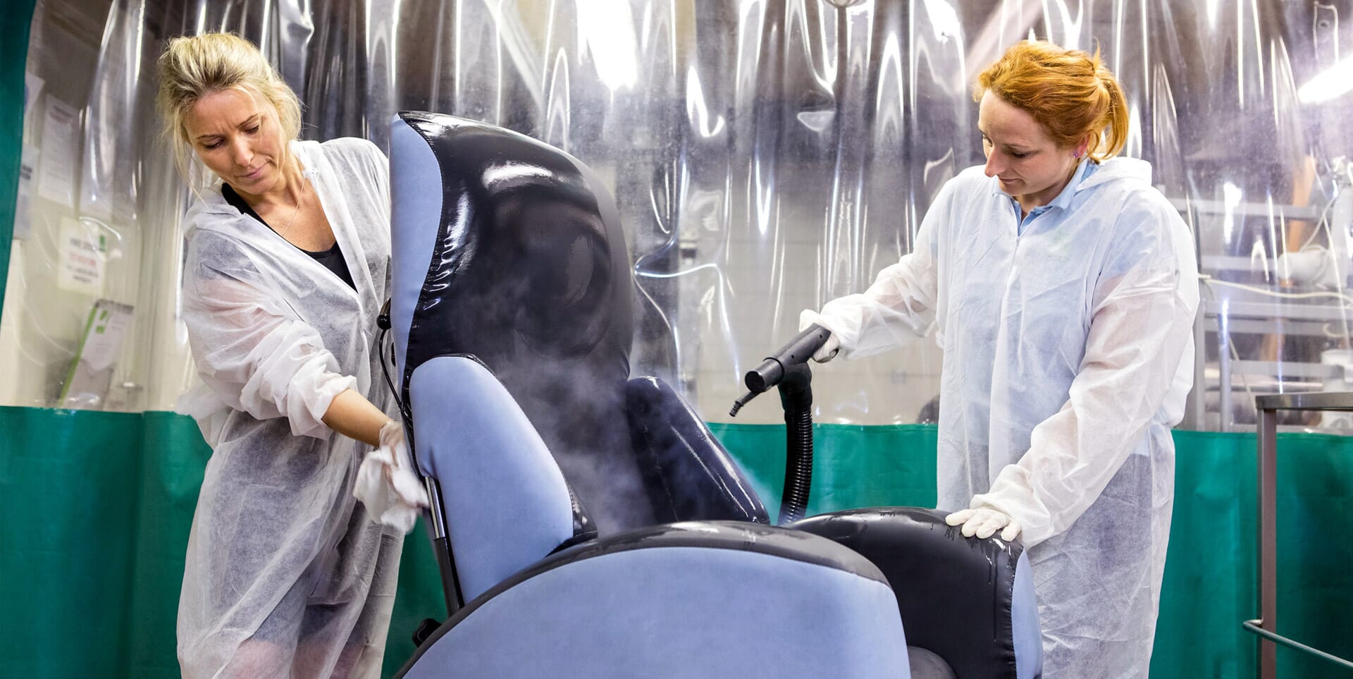 Chair decontamination. Two Women disinfect Grey Chair.