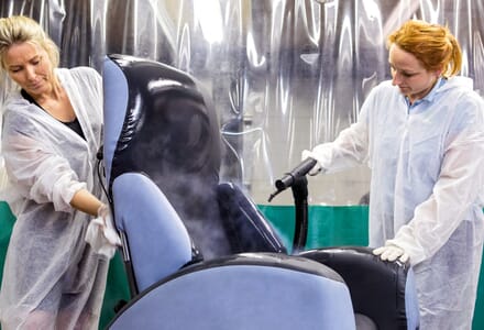 Chair decontamination. Two Women disinfect Grey Chair.