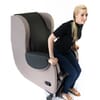 Woman sitting in CareFlex Hydrotilt Chair, facing left.