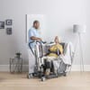 Care Assistant Helping Patent Stand Using  Invacare Birdie EVO Hoist, Grey